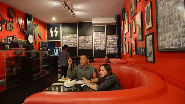 Customers eat at the Soldatenkaffe "The Soldiers' Cafe" in Bandung.