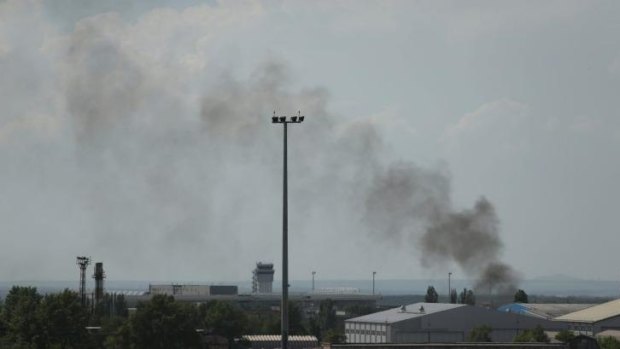 Smoke rises from inside the Donetsk airport area.