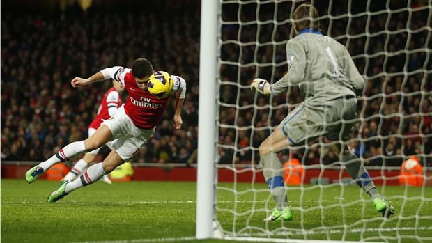 Arsenal's Olivier Giroud heads and scores his first goal past Newcastle United goalkeeper Tim Krul.