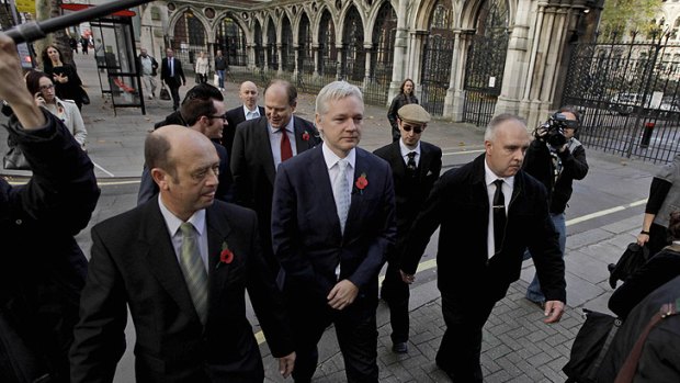 WikiLeaks founder Julian Assange, centre, arrives for his hearing at the High Court in London today.