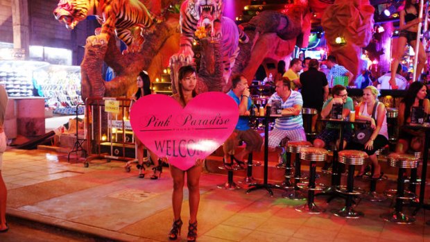 A Thai woman tounts for business at street level in Patong's notorious red light area strip Soi Bang La. Bang La, Patong Beach is very popular with Australian tourists.