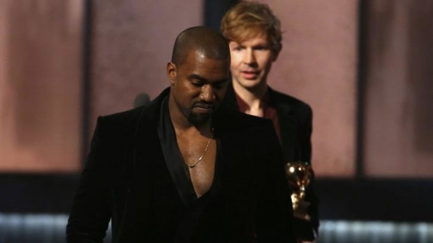 Beck watches Kanye West, who pretended to take the stage after Beck won album of the year at the Grammys.