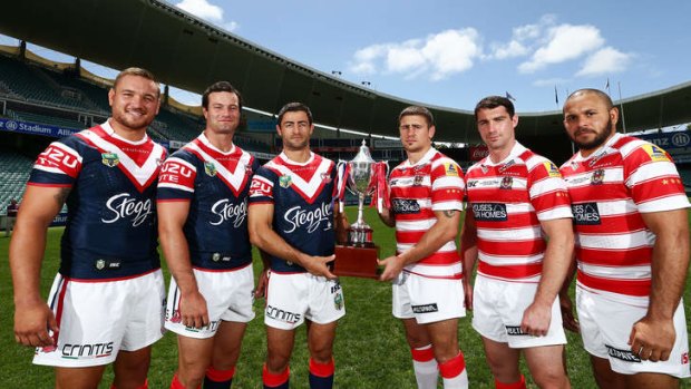 Jared Waerea-Hargreaves, Boyd Cordner and Anthony Minichiello of the Sydney Roosters and Michael McIlorum, Matty Smith and Matt Bowen of the Wigan Warriors pose with the World Club Challenge trophy.