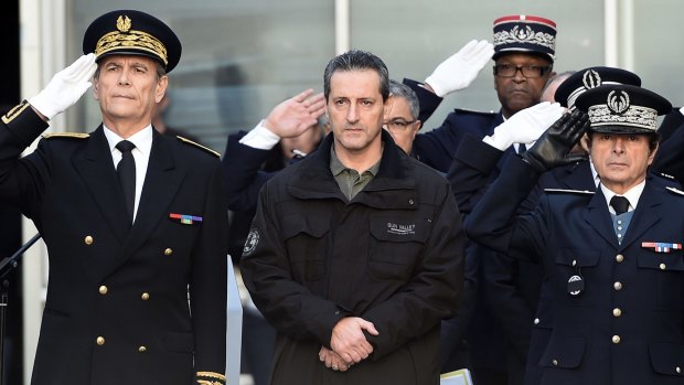 French police officer Philippe Brinsolaro (centre), brother of slain police officer Franck Brinsolaro, observes a minute of silence in Marseille for the victims of the attack.