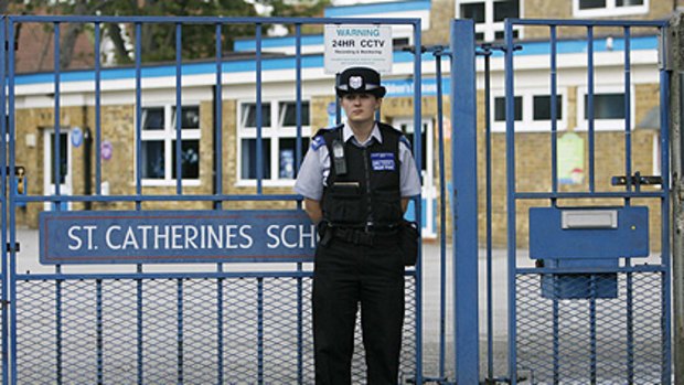 A police officer stands outside St Catherine's Catholic School during a meeting about pupil Chloe Buckley, who died .