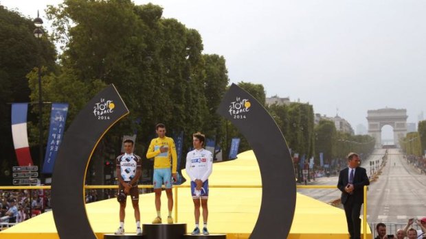 Tour de France 2014's winner Italy's Vincenzo Nibali (C), second-placed France's Jean-Christophe Peraud (L) and third-placed France's Thibaut Pinot (R) pose on the podium on the Champs-Elysees.