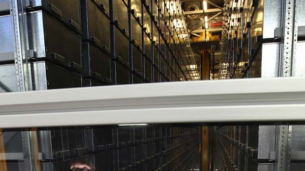 Beam me up ... project assistant Ambrose Wong in Macquarie University library's automated storage and retrieval system.