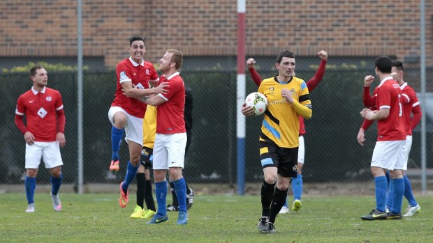 Canberra FC players Josip Jadric and Ian Graham celebrate their side's league championship victory, beating Cooma Tigers FC 3-2 at Deakin Stadium on Sunday.