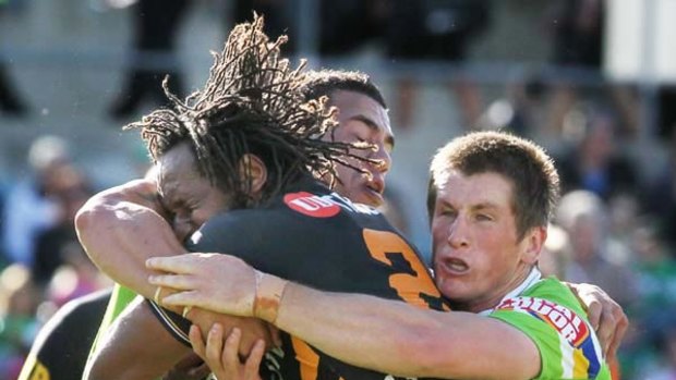 Rage against the machine  ... Lote Tuqiri is wrapped up by the Raiders’ defence. A Tuqiri bust just before half-time  set up Benji  Marshall’s try that sparked a stunning second-half comeback.