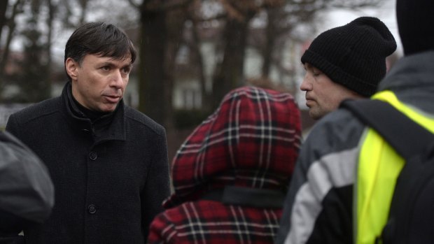 Patrik Kuncar (left), mayor of Uhersky Brod, speaks with a citizen near a restaurant where a gunman opened fire.