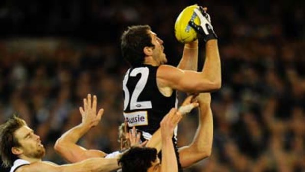 Travis Cloke leaps to take a strong mark.