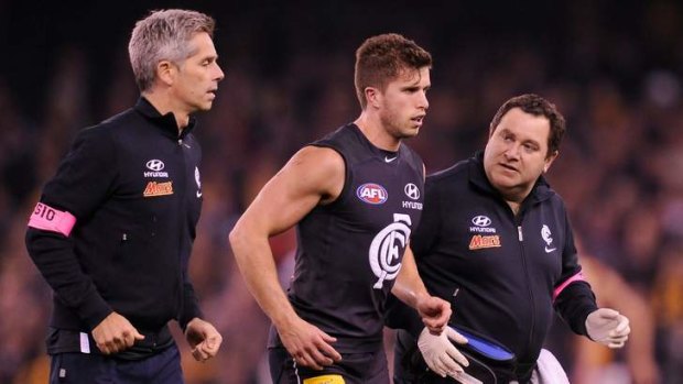 Marc Murphy comes off injured after clashing with Hawthorn's skipper Luke Hodge.