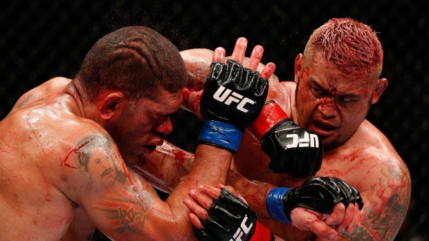 Mark Hunt elbows Antonio "Bigfoot" Silva in their heavyweight fight during the UFC Fight Night event at the Brisbane Entertainment Centre on December 7, 2013 in Brisbane, Australia.