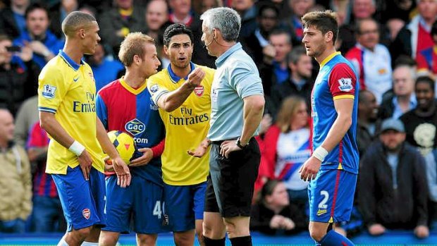 Goal and red card:  Mikel Arteta of Arsenal argues with referee Chris Foy after being sent off.