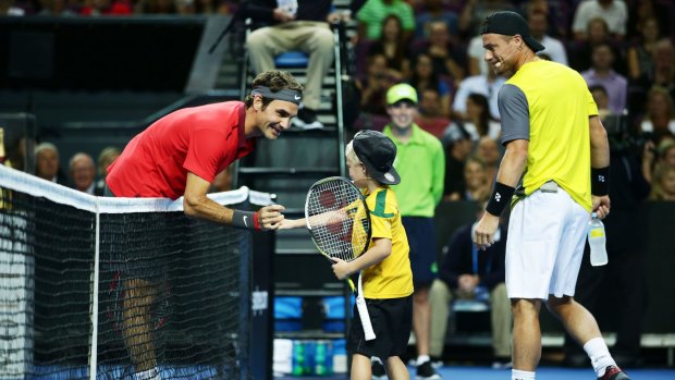 How do you do: Roger Federer interacts with Lleyton Hewitt's son Cruz Hewitt before their Fast4 match at Sydney's Qantas Credit Union Arena.