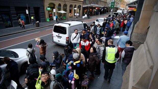 People queue for the new Apple iPhone 6 at the Sydney CBD store.