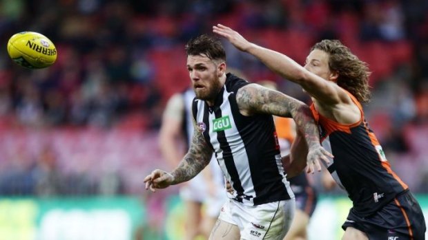 Neck and neck: Magpies midfielder Dane Swan challenges Giants defender Mark Whiley for the ball.