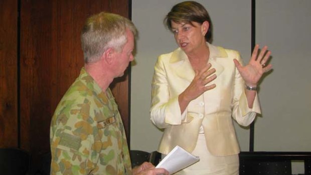 Major General Mick Slater, who heads the Queensland Reconstruction Authority, speaks to Queensland Premier Anna Bligh at a meeting with local government representatives.