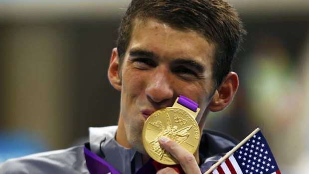 Historic achievement ... Michael Phelps shows off his 19th Olympic medal.