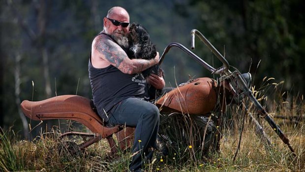 Challenges: Rob Greig and Missy astride his beloved burnt-out Harley, five years after the Black Saturday fires.