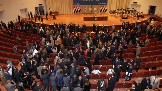 Walking out: New Iraqi parliament members argue then leave the first session in Baghdad. 