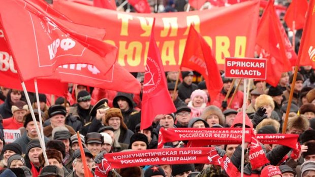 Supporters of the Russian Communist Party wave red flags and banners during a rally in Moscow.