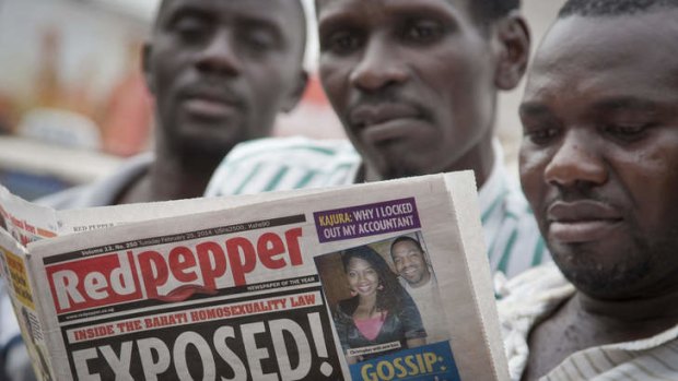 Exposed: Locals reads a copy of the <i>Red Pepper</i> tabloid newspaper in Kampala.