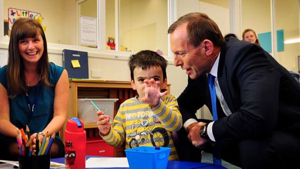 Opposition Leader Tony Abbott meets Ethan Ellis, 4, on a visit to the Little Learners Autism Centre in Maidstone.