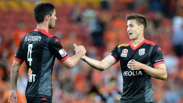 Dylan McGowan and Michael Marrone of Adelaide celebrate their 2-1 win over the Queensland Roar.