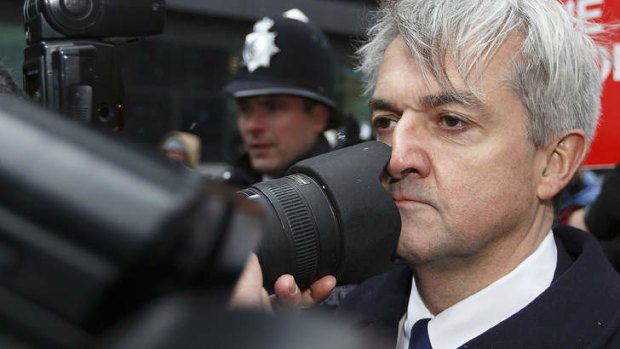 Media glare: A stoic Chris Huhne arrives at Southwark Crown Court.