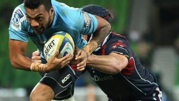 Alofa Alofa of the Waratahs is tackled by Cadeyrn Neville of the Rebels