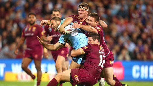 Standards: Wade Graham of the Blues is tackled by Matt Gillett and Josh McGuire of the Maroons during game one of the State Of Origin series last month.