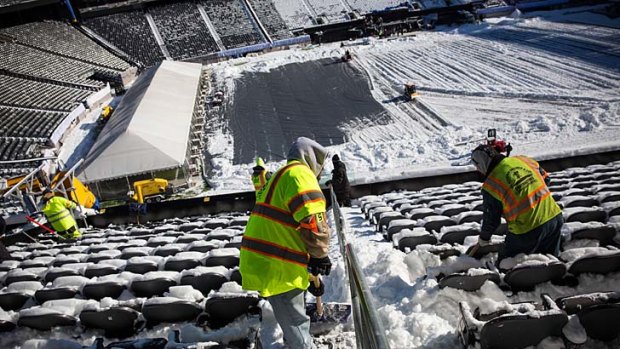 Crews work to remove snow from MetLife Stadium, which will host Superbowl XLVIII.