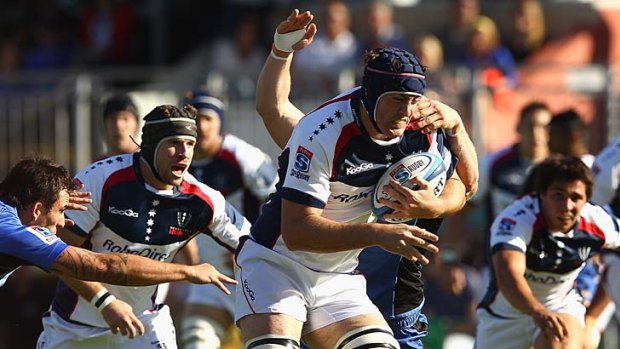 Winning ways: Cadeyrn Neville is tackled in the Rebels' victory against Western Force.