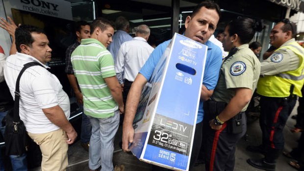 A man takes home a new TV in Caracas.