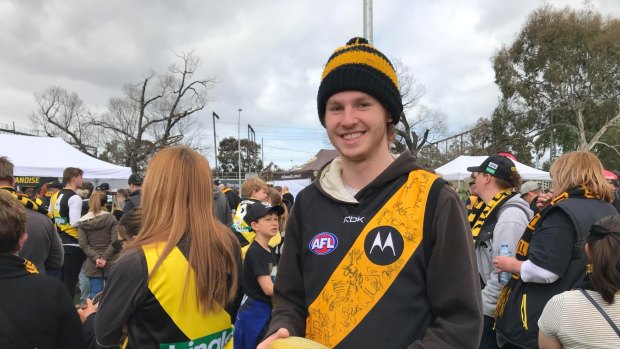 He joined hundreds of people who were queuing for merchandise at Punt Road Oval. He has his eyes set on a $40 premiership T-shirt.