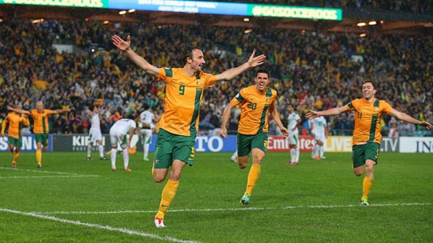 Josh Kennedy celebrates scoring the goal to send the Socceroos to Brazil.