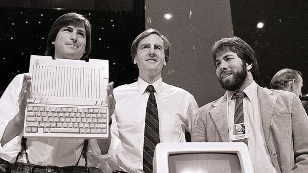 Steve Jobs, far left, unveils the new Apple IIc computer in 1984.