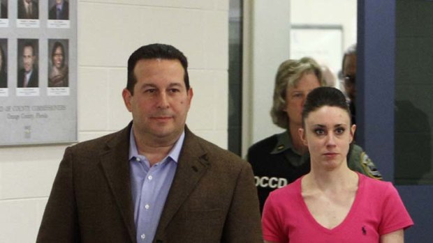 Out of the frying pan ... Casey Anthony walks free from the Orange County Jail, Florida, with her lawyer, Jose Baez on Sunday.