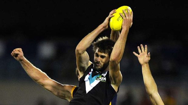 Huge turnaround: Port's Justin Westhoff soars above the pack to mark, as Crows players struggle to compete.