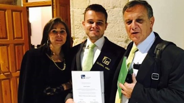 Javier Camelo with his parents at his graduation. 