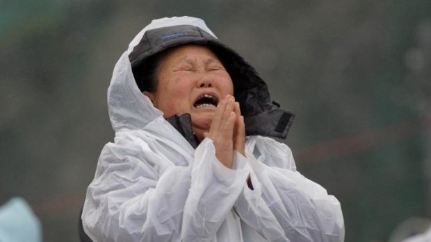 A relative weeps as she waits for missing passengers of the sunken ferry. 