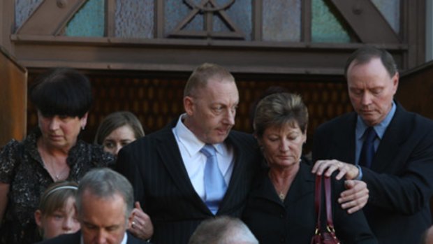 Michelle Beets's partner, David Grant, centre, leaves the funeral service yesterday.