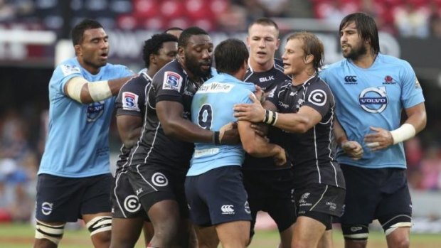 Waratahs half-back Nick Phipps in a spot of bother against the Sharks in Durban on Saturday.
