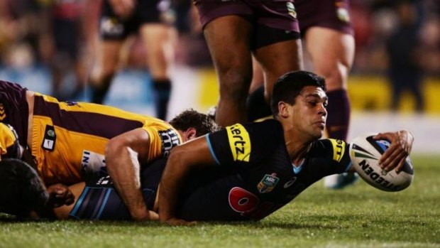 Peach battle: Tyrone Peachey is tackled just short of the line.