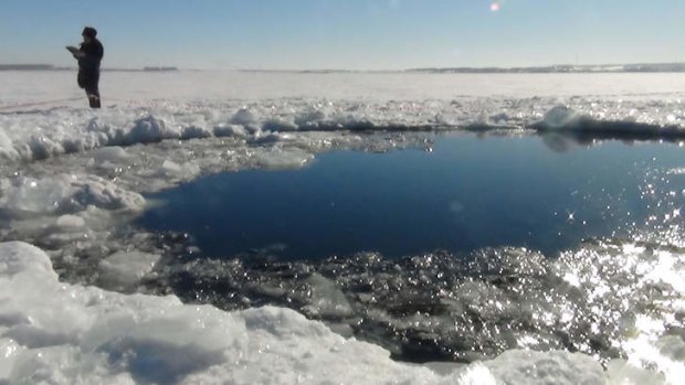 The hole in the ice believed to have been made by part of the meteor.