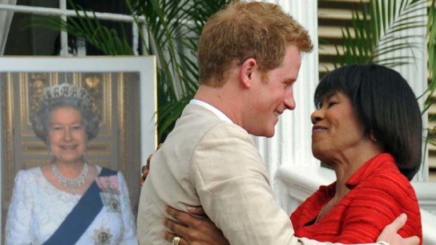 Charm offensive &#8230; the prince diffuses a potentially tense situation by hugging Jamaica's Prime Minster, Portia Simpson Miller, who wants the island to become a republic.