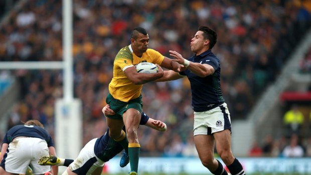 Australia's Kurtley Beale (centre) evades the challenges of Scotland's Finn Russell (left) and Sean Maitland during the 2015 Rugby World Cup in England. 