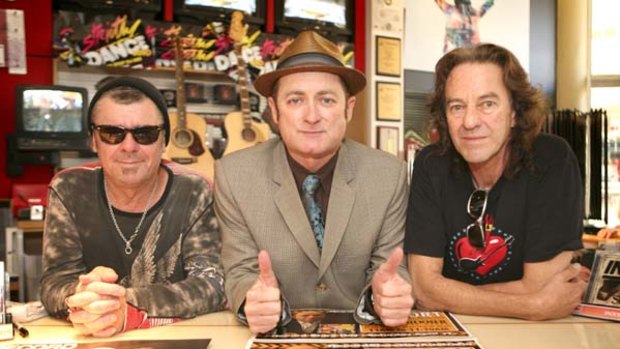 Counter action … Tim Farriss, Dave Faulkner and Fess Parker gave recorded music the thumbs up when they visited Mall Music, Warringah Mall, for Record Store Day Australia.