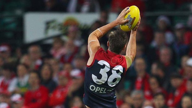 Jeremy Howe of the Demons takes a screamer against the Swans.